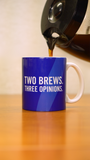 A coffee pot pouring coffee into a blue mug that says "Two Brews. Three Opinions." in white letters.
