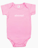 Pink baby onesie with the word ‘aboose!’ printed in white.