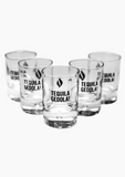 The photo features five clear shot glasses with the phrase ‘Tequila Gedola!’ and UJA flame logo printed on each glass.