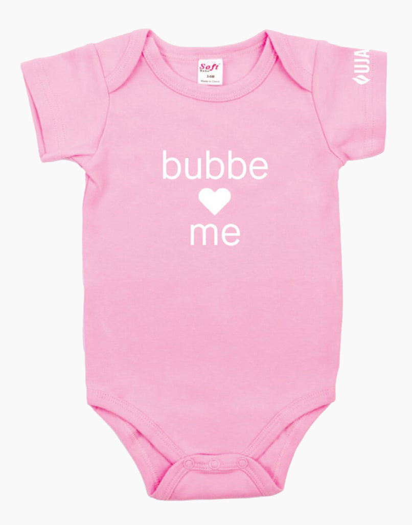Pink onesie that says "bubbe loves me" in white letters on the front. There is a heart instead of the word love. 